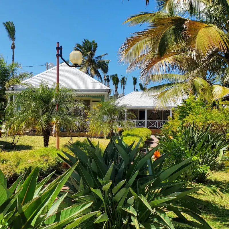 La case créole d'Anse des Cocos, avec sa varangue, ses lambrequins et son jardin de palmiers